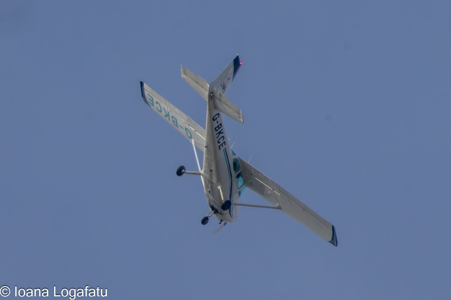 Aircraft soaring high above the clear blue sky